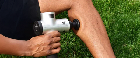 man using hypervolt massage gun on calf
