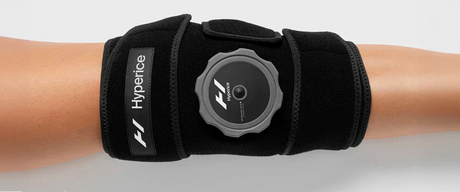 Closeup image of a woman's leg wearing the Hyperice Knee Wrap on her knee