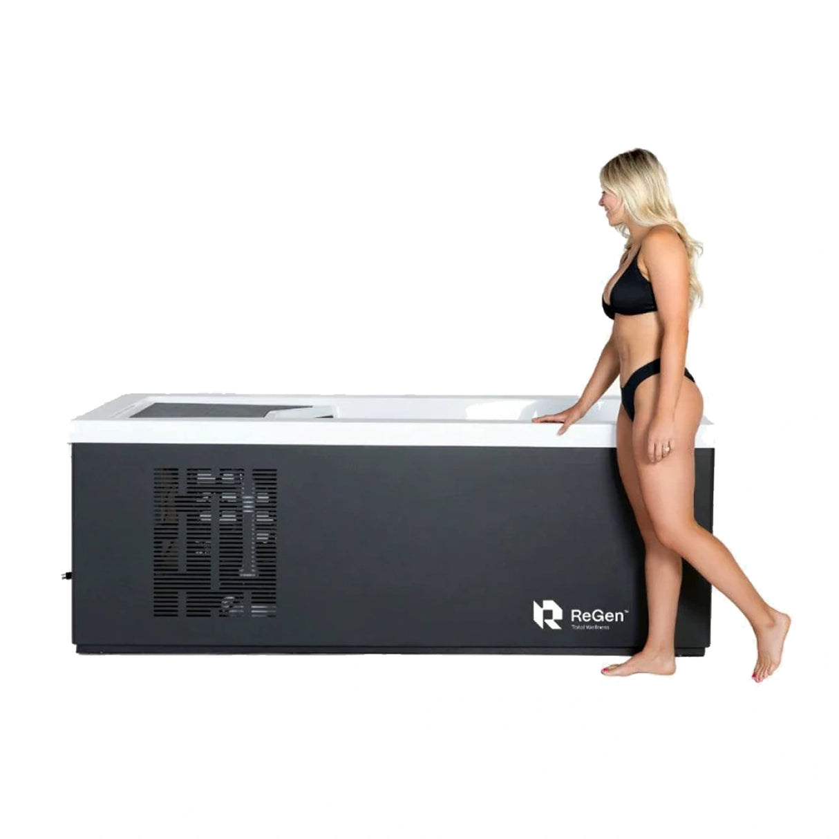 A rectangular cold plunge with a black exterior and white acrylic interior with an attractive blond woman in a black bikini walking along the side of it