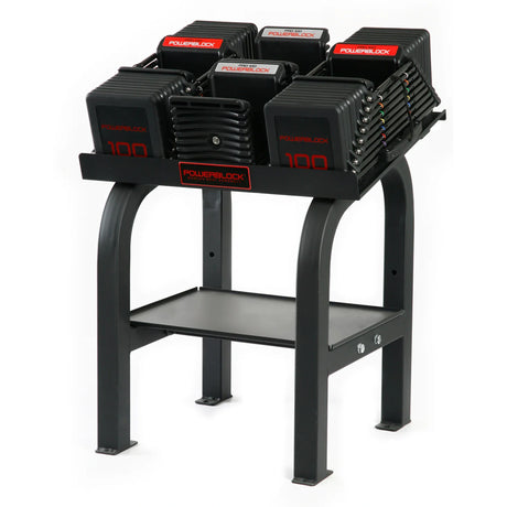 A PowerBlock Commercial Pro Rack Stand with dumbbells and handles on it