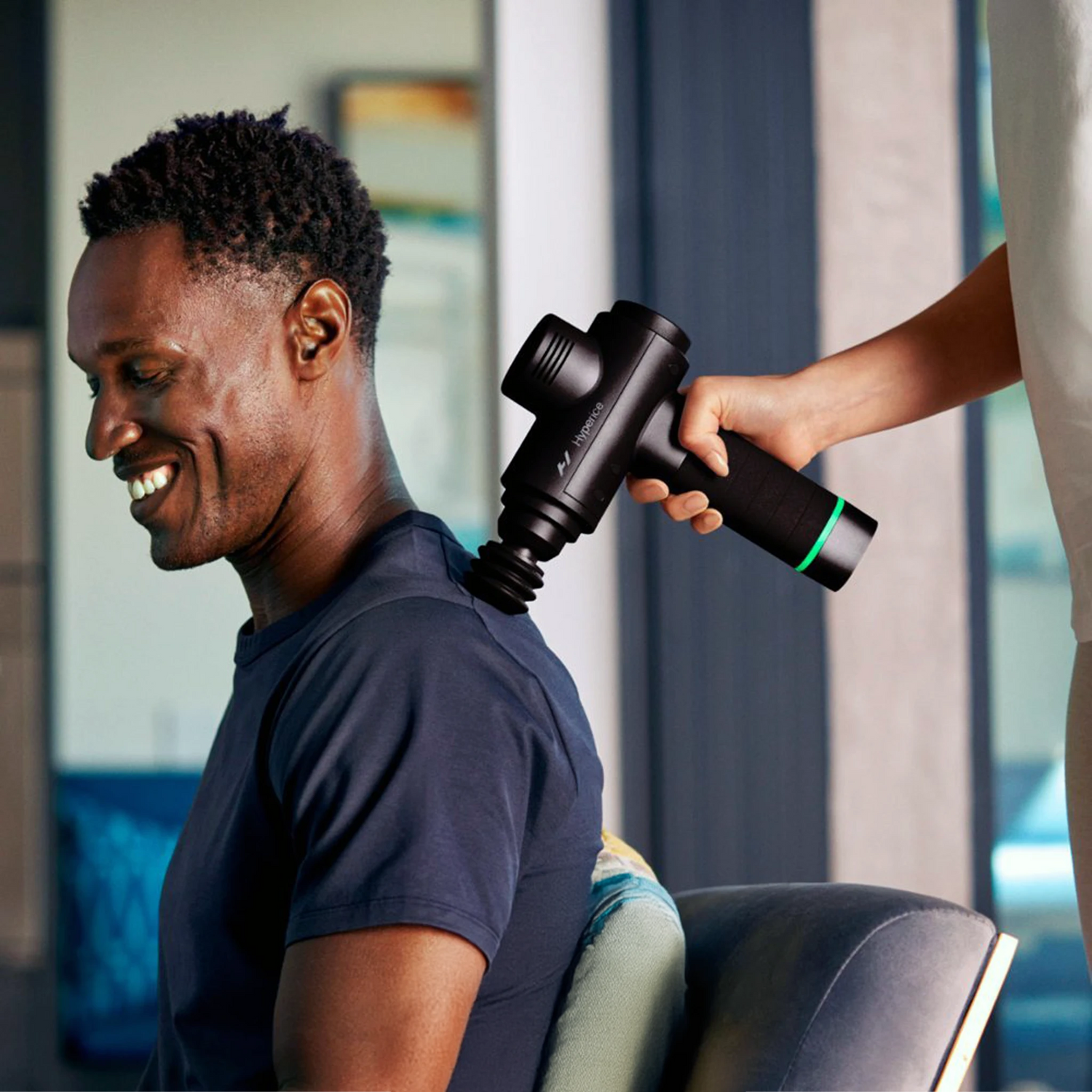 Cushion massage gun attachment in a massage gun being used on a mans back