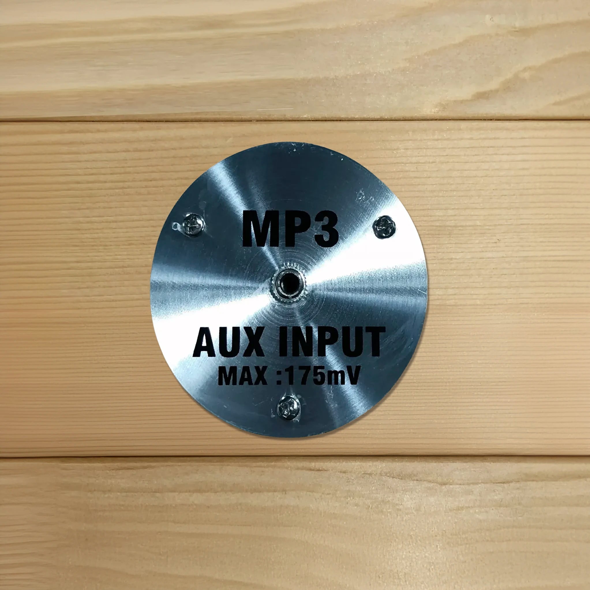 AUX MP3 input for an auxiliary cord to plug into which is found inside of a wooden sauna sold by Blue Sky Fitness Supply