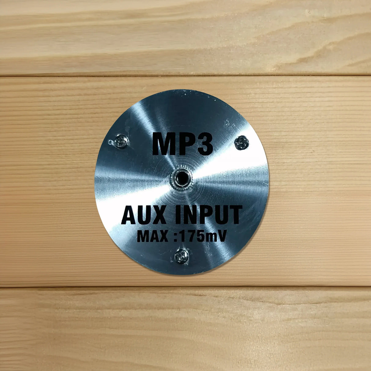 AUX MP3 input for an auxiliary cord to plug into which is found inside of a wooden sauna sold by Blue Sky Fitness Supply