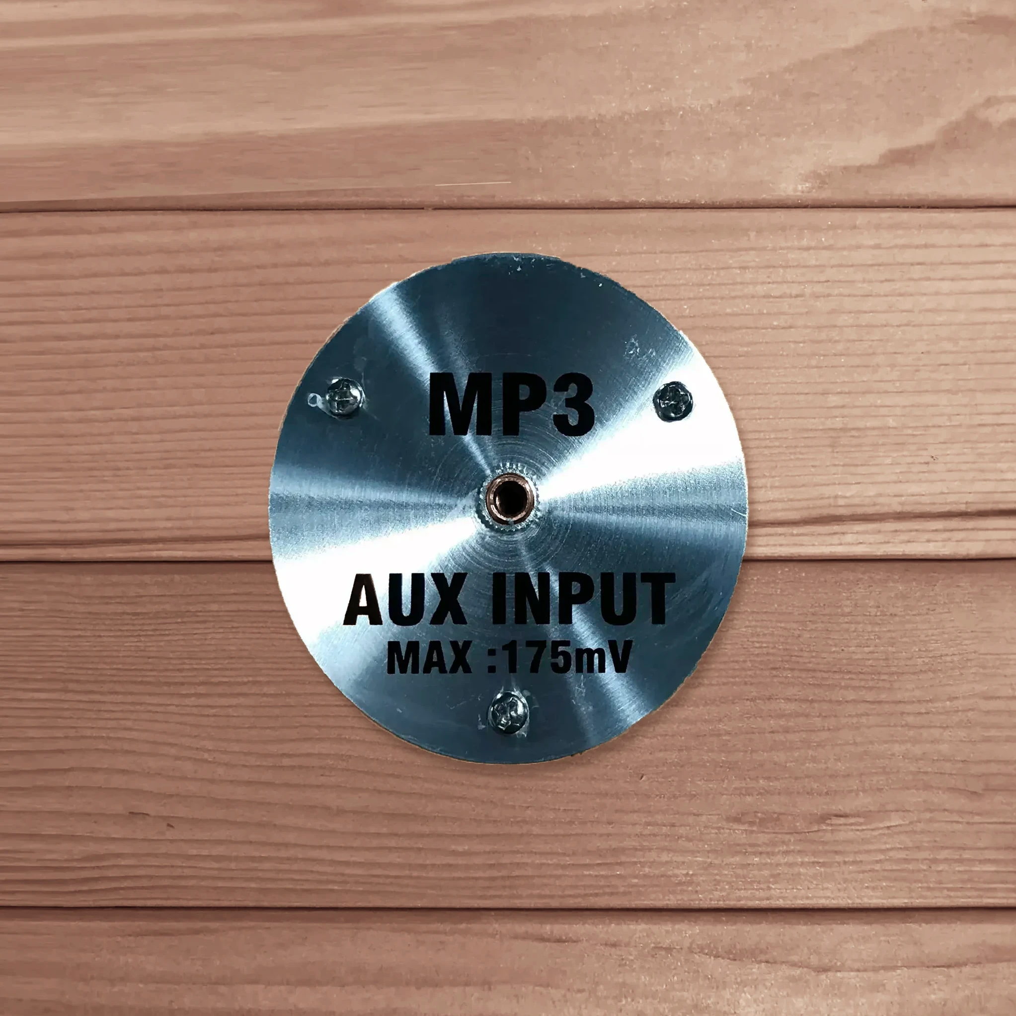 AUX MP3 input port for an auxiliary cord found inside of a wooden sauna