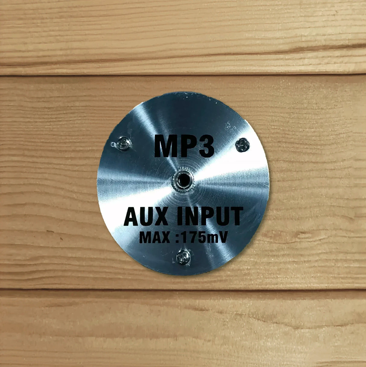 MP3 AUX port for an auxiliary cord to insert into built into the wooden wall of a home sauna
