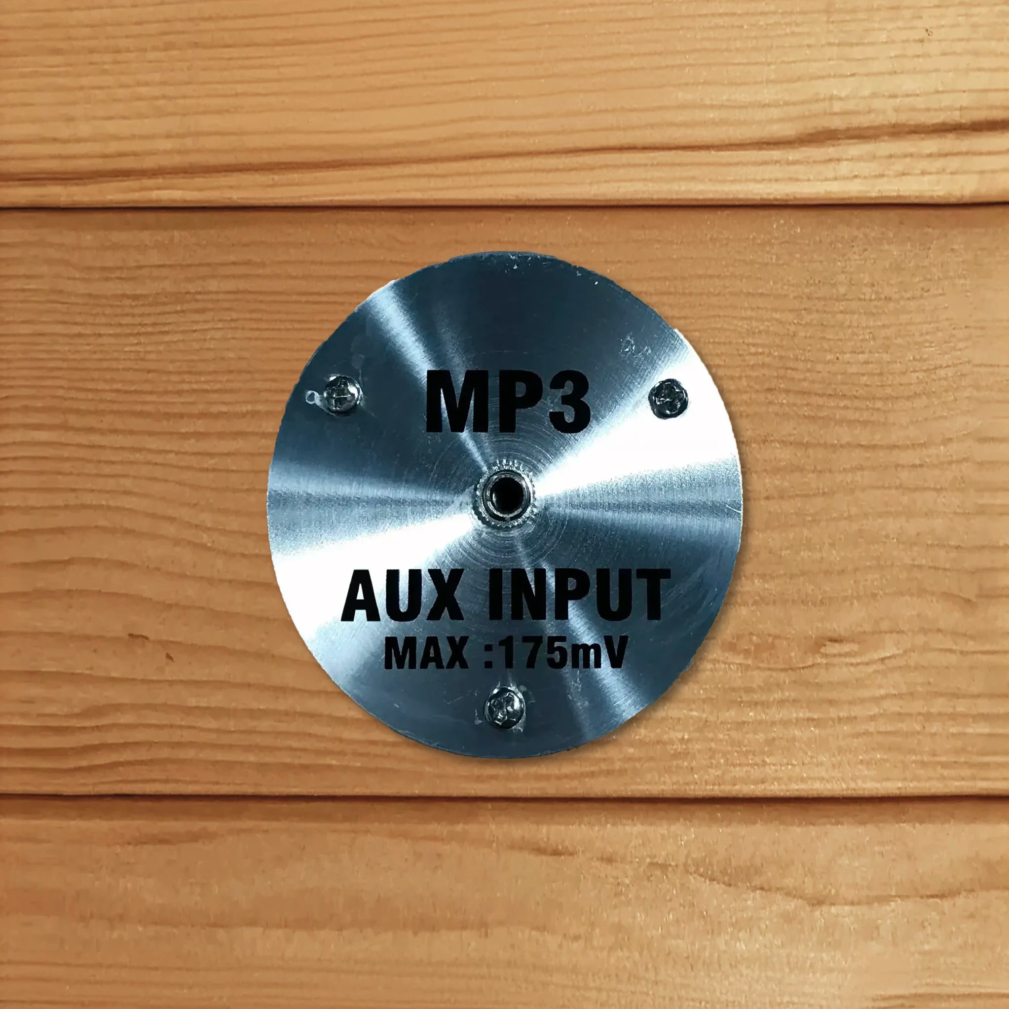 MP3 auxiliary input jack inside a wooden sauna