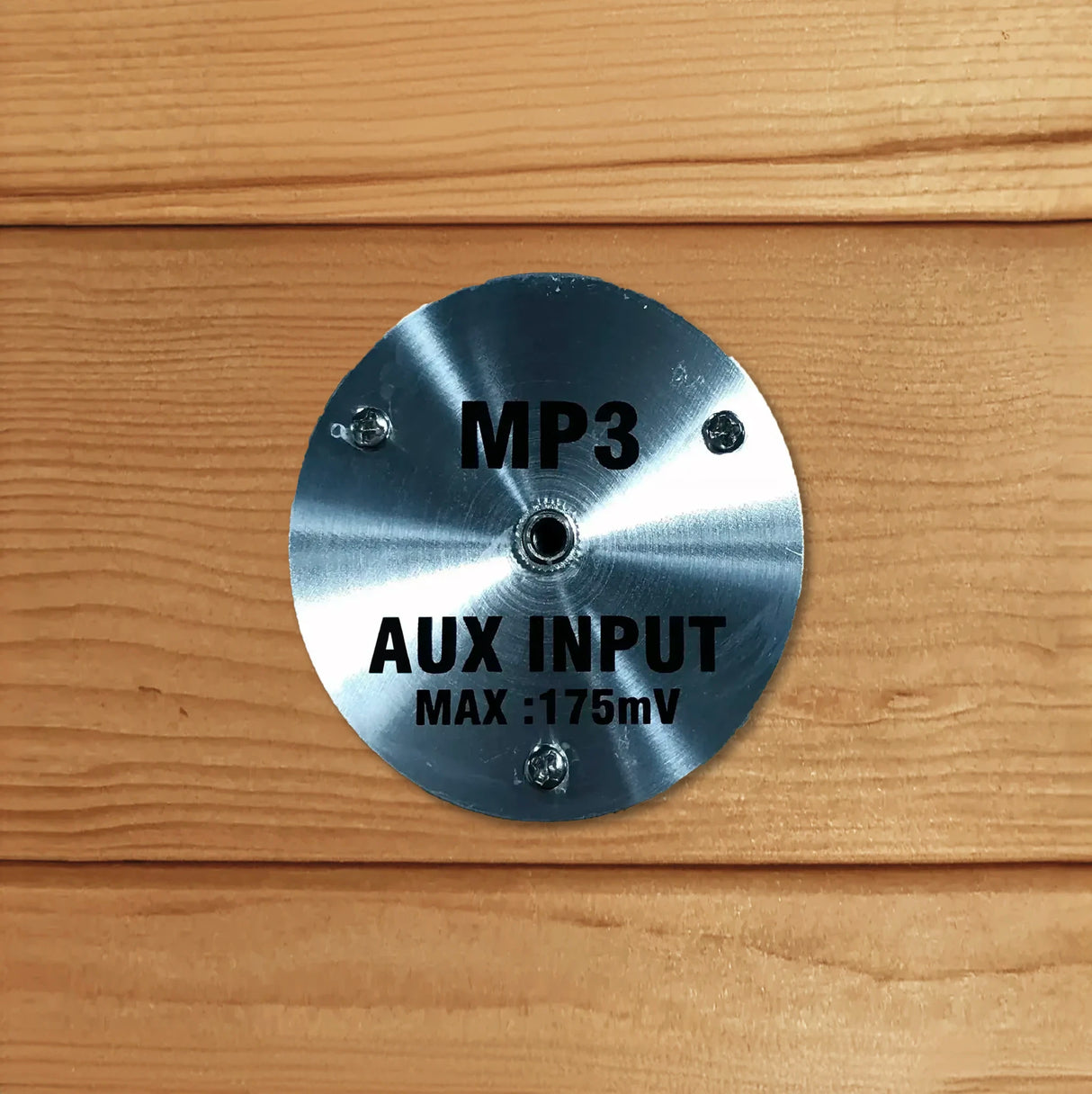 MP3 auxiliary input jack inside a wooden sauna