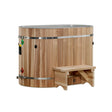 Wooden oval red cedar cold plunge with a portable step on a white background