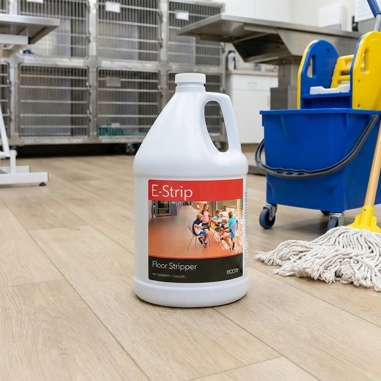 E-Strip floor stripper bottle on a wooden floor with cleaning equipment in the background in a vet clinic