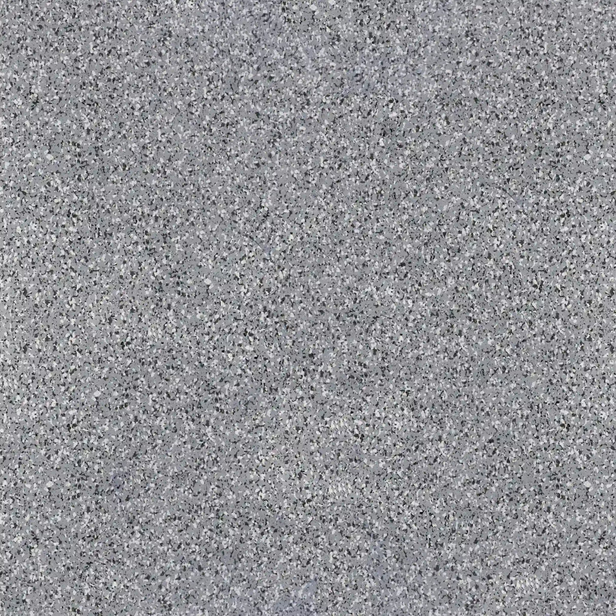 Close-up view of ECORE Athletic PlayGuard Rubber Tile - 2.5" Playground Flooring, featuring a gray, speckled surface with mixed light and dark gray spots for a textured appearance ideal for playgrounds.