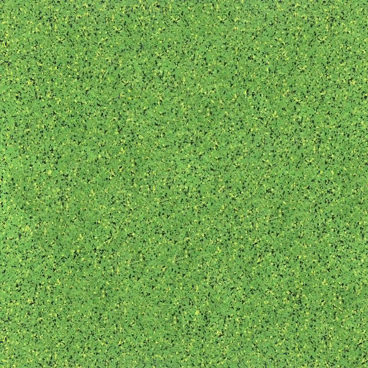 A close-up of ECORE Athletic’s PlayGuard Rubber Tile 2.5" Playground Flooring shows a green, textured surface with specks in various shades, resembling artificial turf.