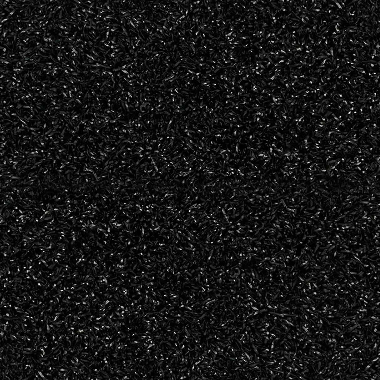 Close-up view of ECORE RageTurf Rally Interlocking Tile by ECORE Athletic, a dense, textured black 12mm athletic turf tile featuring small, curled, shiny fibers throughout its resilient surface.