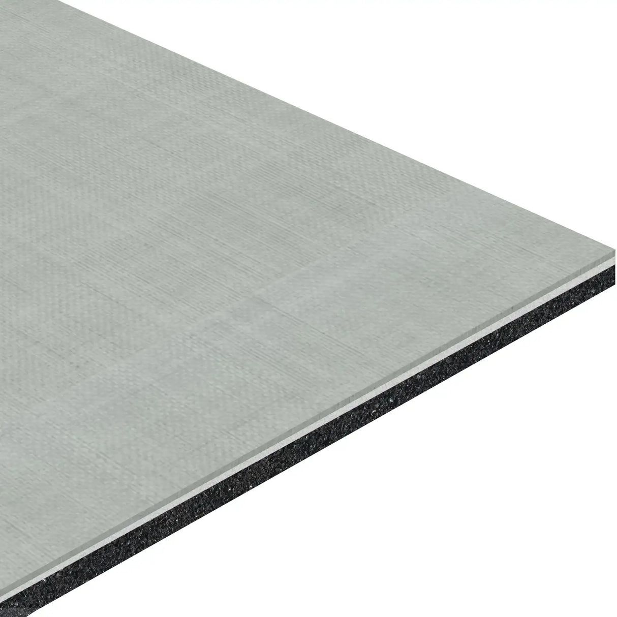 A close-up of the ECORE Serenity Motivate Laminate Roll - 7mm Class 1 Flooring by ECORE Athletic shows its rectangular, layered structure with a textured light gray surface and dark inner core, emphasizing its thickness.
