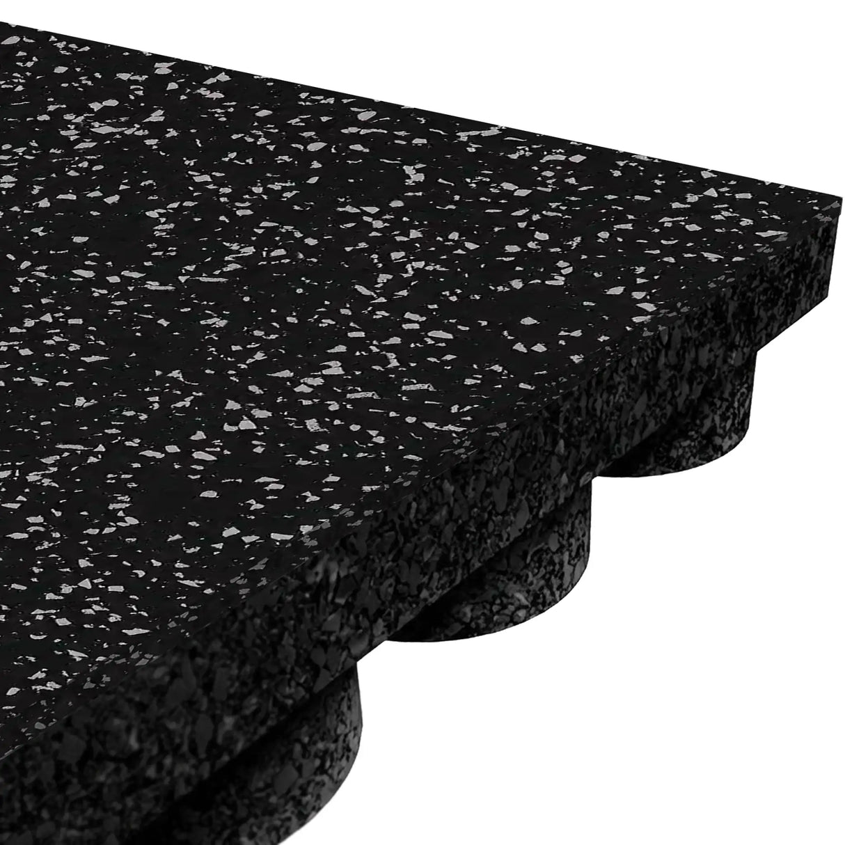 Close-up of the ECORE Performance UltraTile - 1" Rubber Tile by ECORE Athletic, featuring thick black rubber with white speckles, a textured top surface, and a bottom layer with raised circular support nubs.