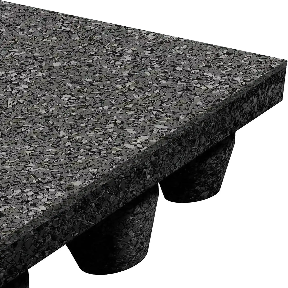 Close-up of the ECORE Athletic Performance dBTile Rubber Tile - 2.5" Acoustic Flooring, a thick, speckled black mat with beveled edges, raised on round rubber feet for space underneath.