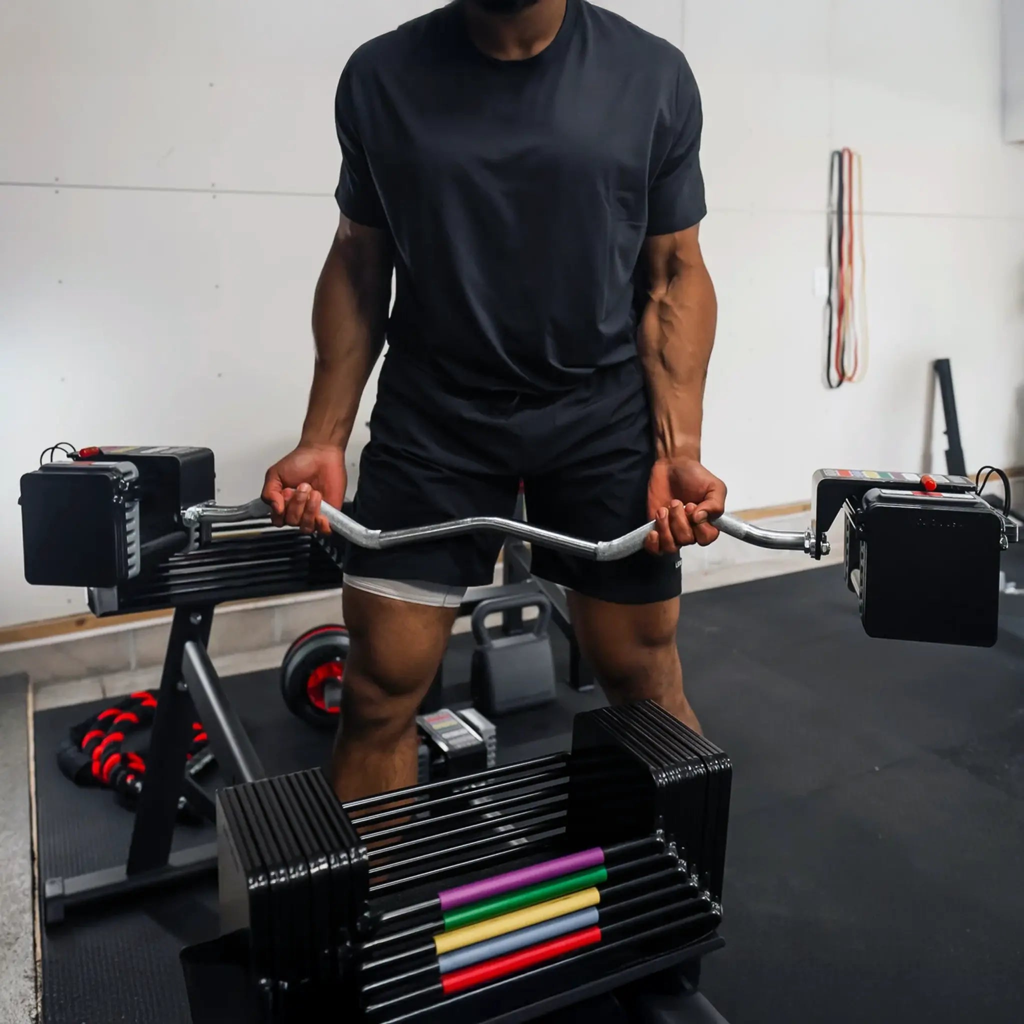 Man holding a PowerBlock EZ barbell