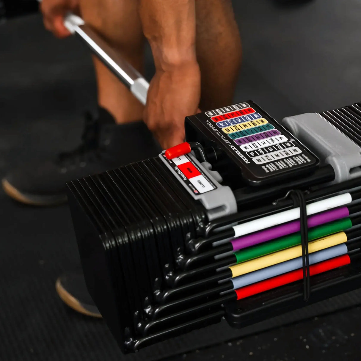 Man deadlifting a PowerBlock straight barbell