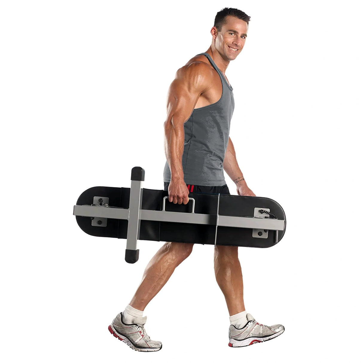 A PowerBlock Fold Up Portable Travel Bench in the folded position being carried by a man by the handle
