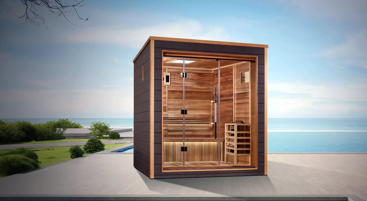 Drammen model sauna with a 3 person capacity made from Canadian red cedar on the interior and dark all weather composite on the exterior built for outdoor use on a deck overlooking the ocean