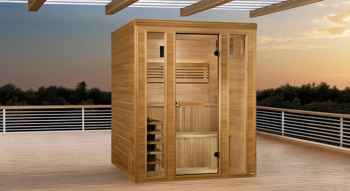 Golden Designs Engelberg model traditional steam sauna built for indoor or covered outdoor use constructed from pacific cedar on the inside and outside with a six person capacity on a covered deck at sunset