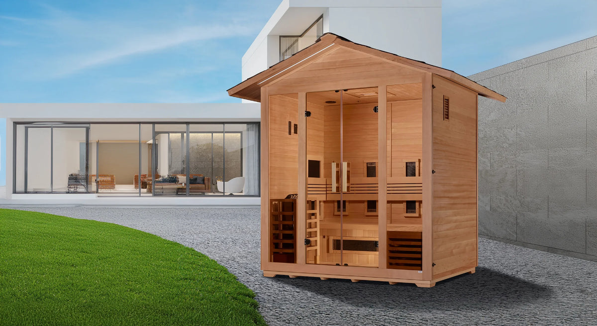 Golden Designs Gargellen model hybrid full spectrum infrared traditional steam sauna built for outdoor use with a 5 person capacity and a gabled roof which is constructed from Canadian hemlock wood in the back yard of a house