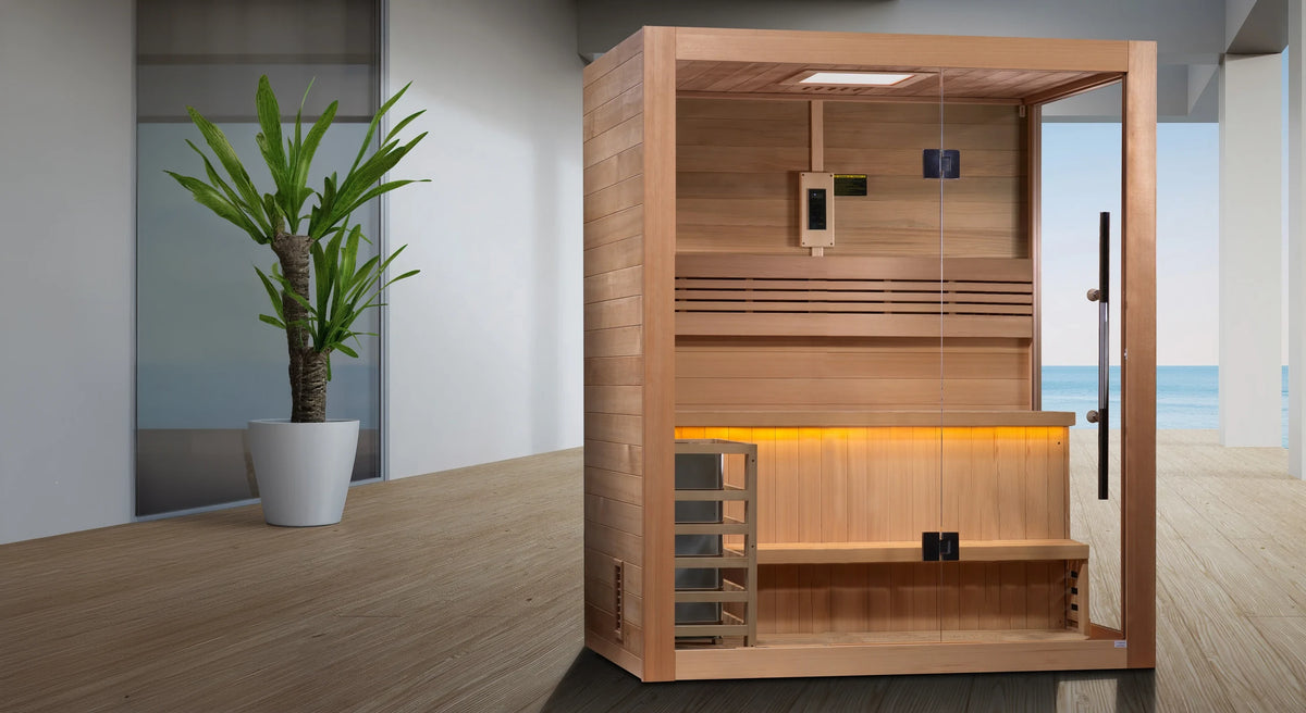 Golden Designs Hanko model traditional steam sauna built for indoor or covered outdoor use constructed from Canadian red cedar on the inside and Canadian hemlock on the outside with a three person capacity on a wooden deck overlooking the ocean