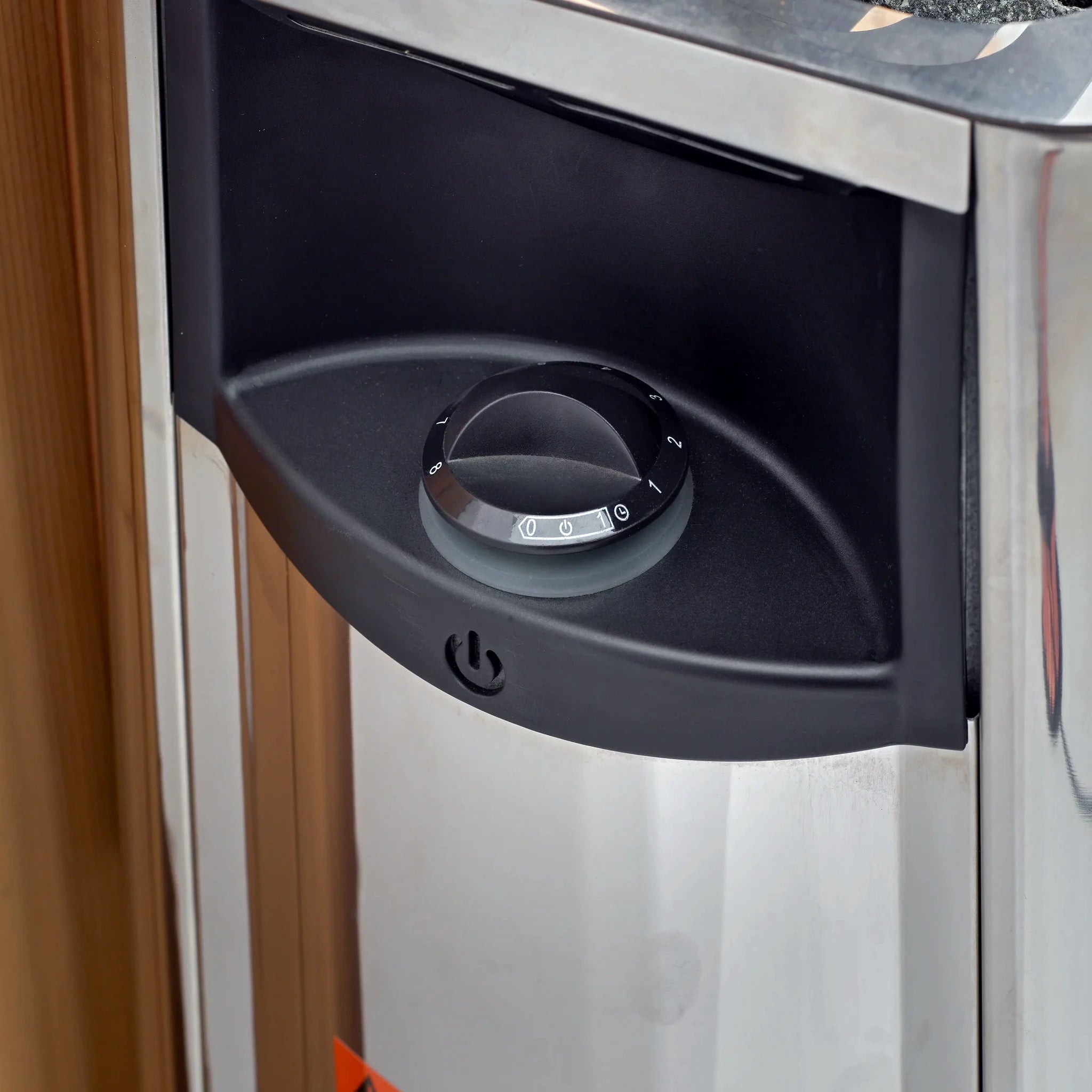 A traditional steam sauna Harvia model wall stoveTraditional steam sauna Harvia brand wall-mounted stove