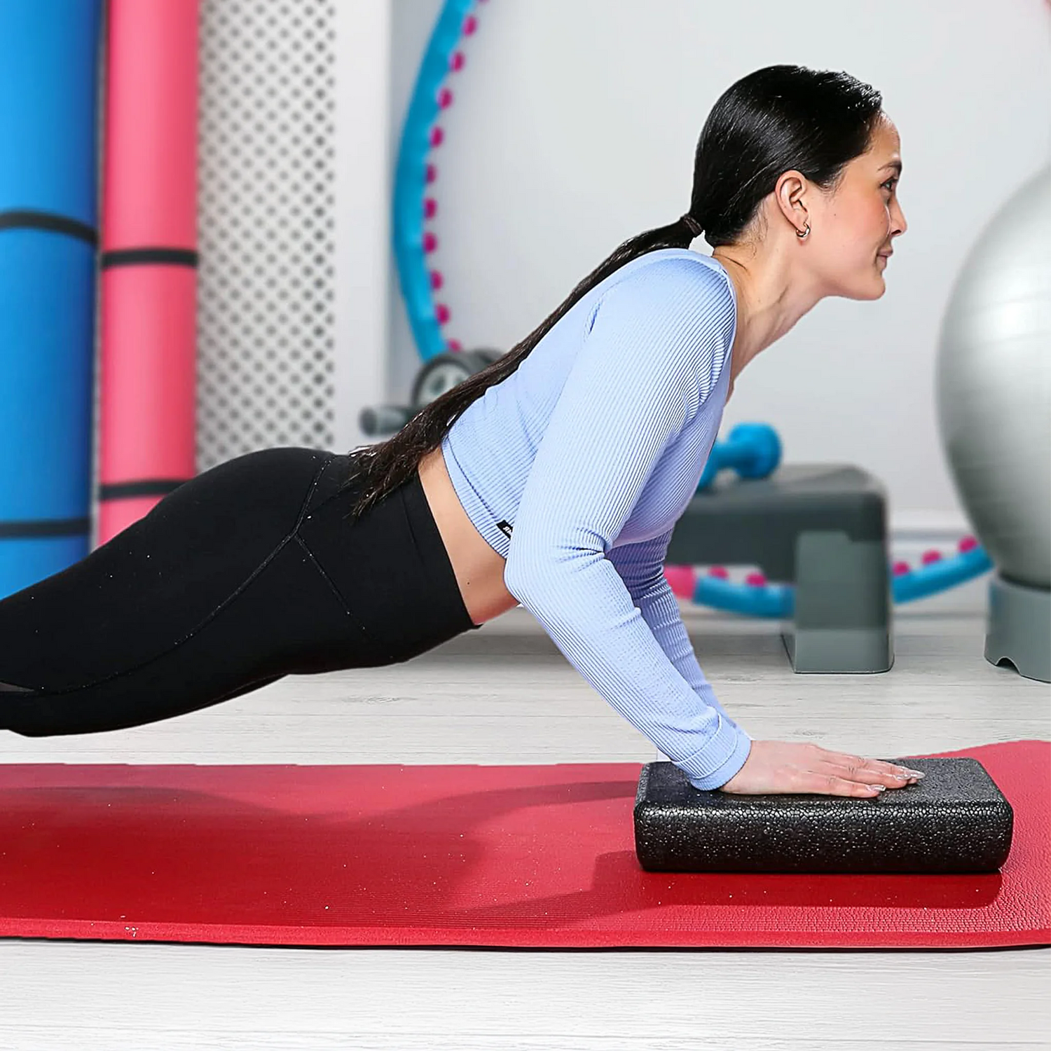 Woman doing pushup on high density short semi circle foam roller by CanDo