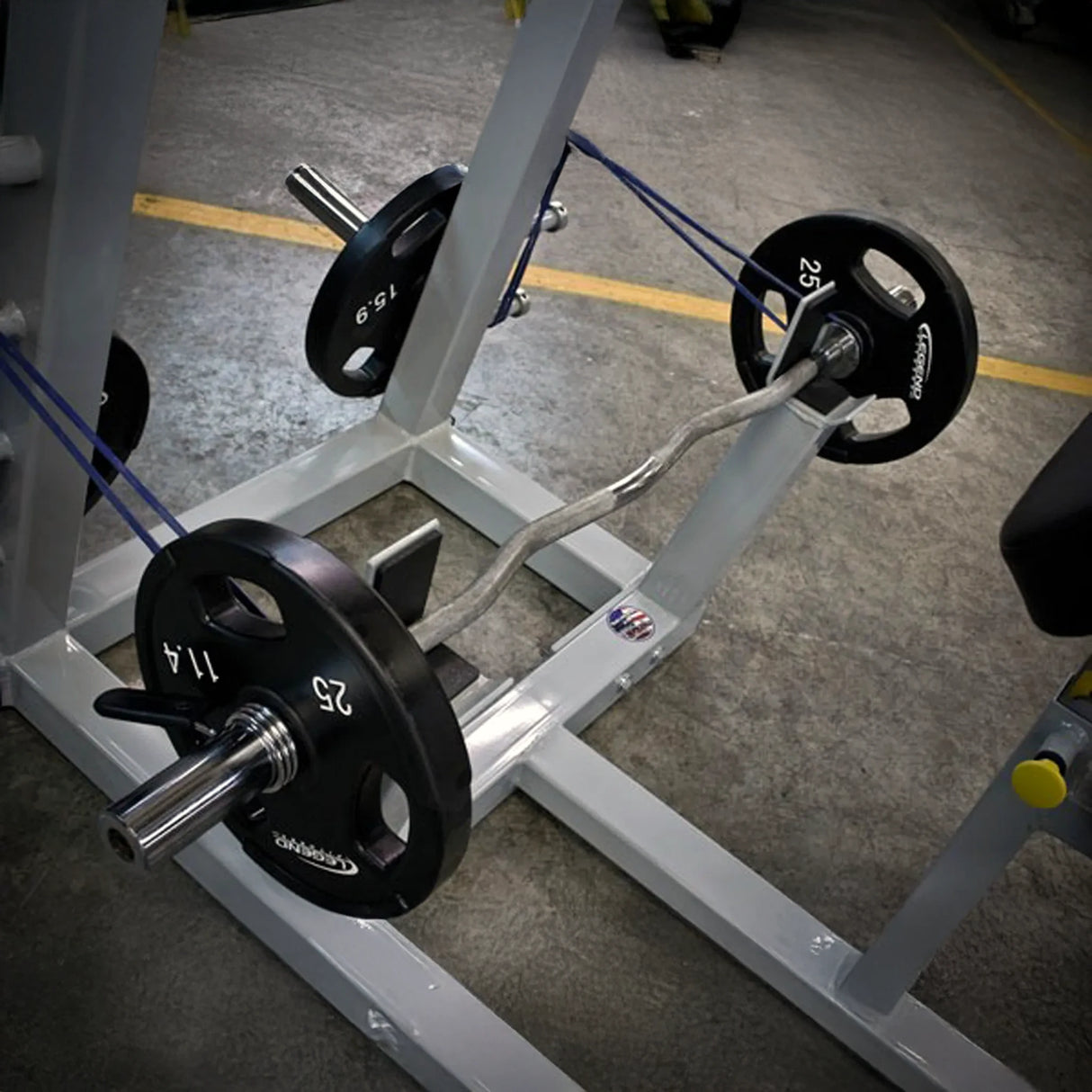 Weightlifting machine with weight plates on a concrete floor