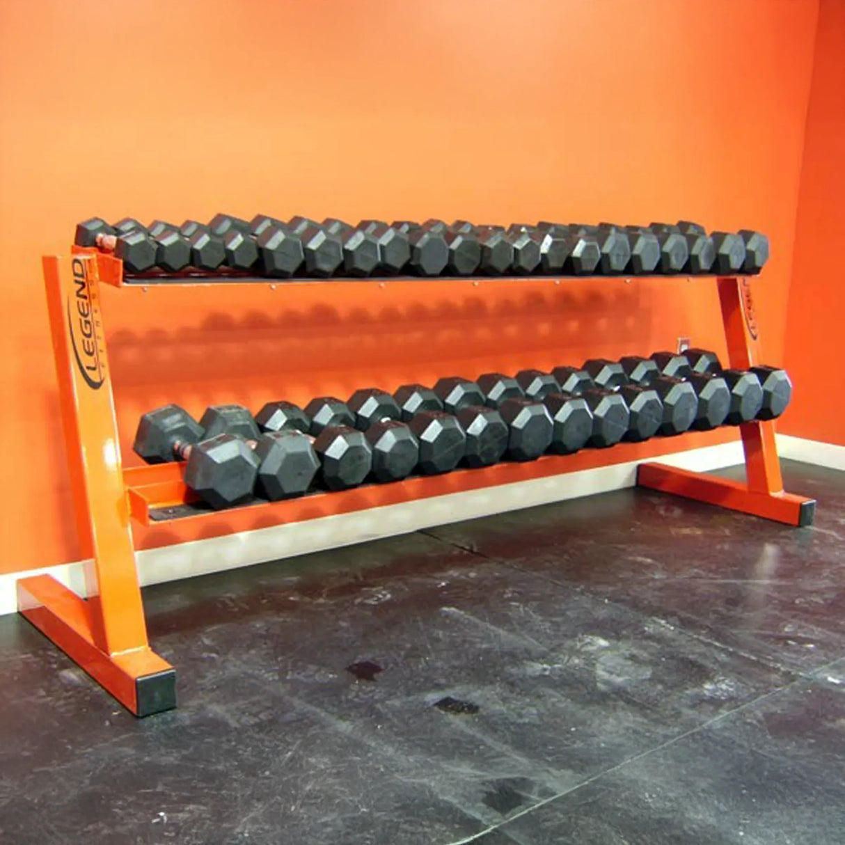 Dumbbell rack with black dumbbells on an orange wall background