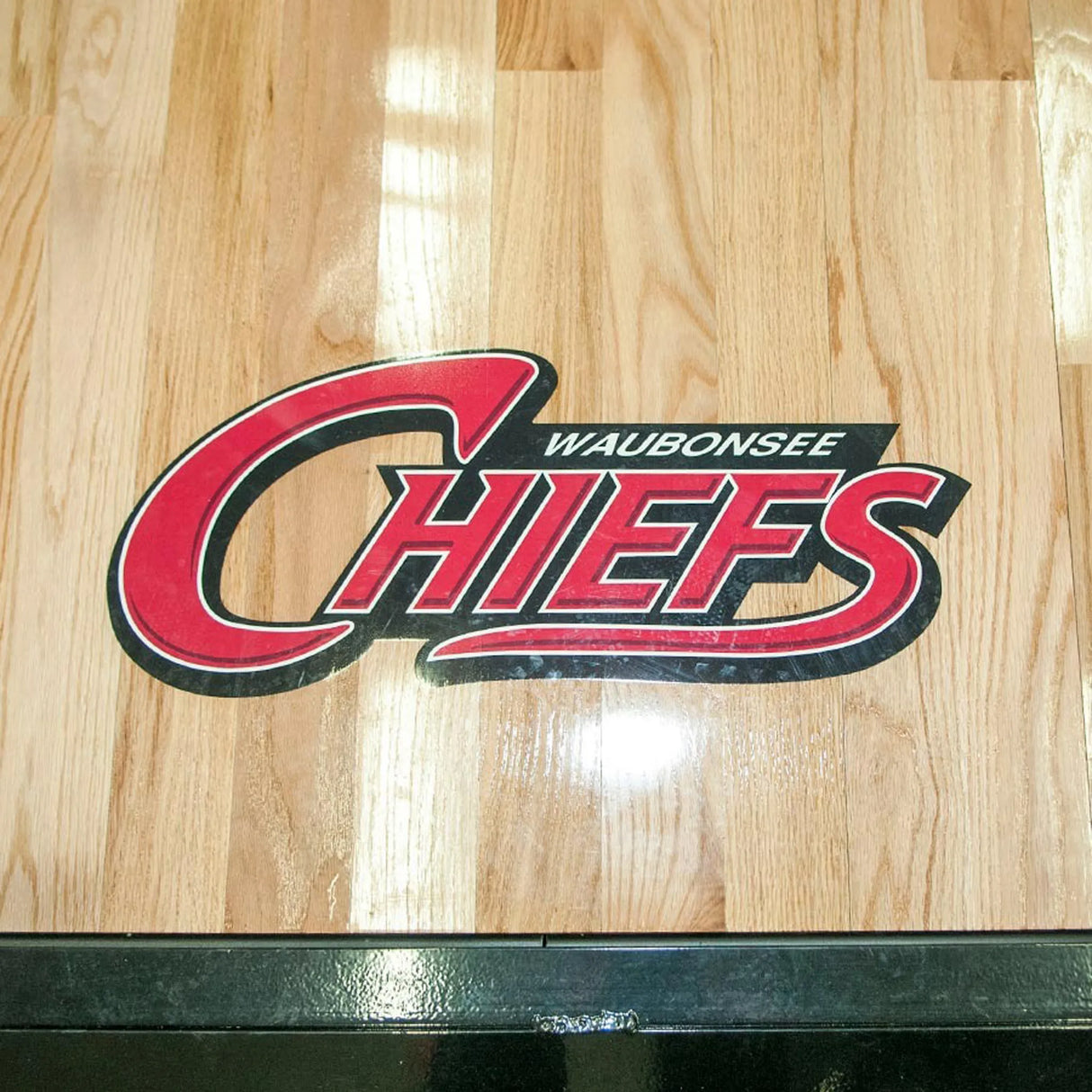 Waubonsee Chiefs logo on a wooden surface