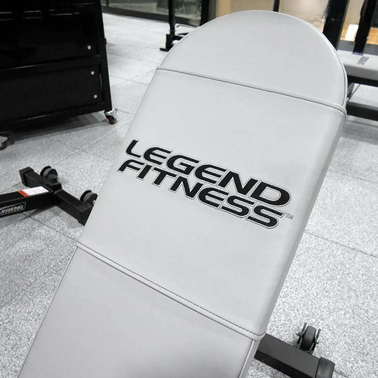 A gray bench pad with 'Legend Fitness' embroidered on it