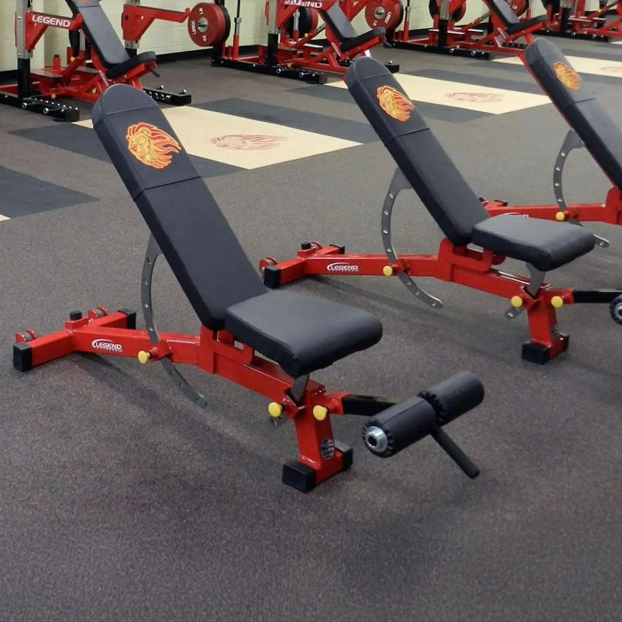 Red and black weight benches in a gym setting