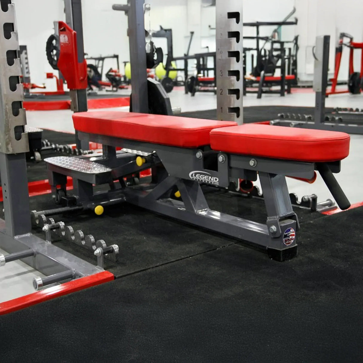Red weight bench with adjustable backrest in a gym setting