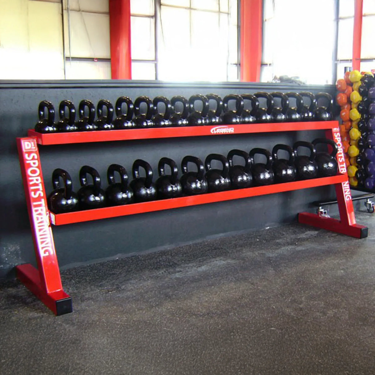 Red weight rack with black dumbbells in a gym setting