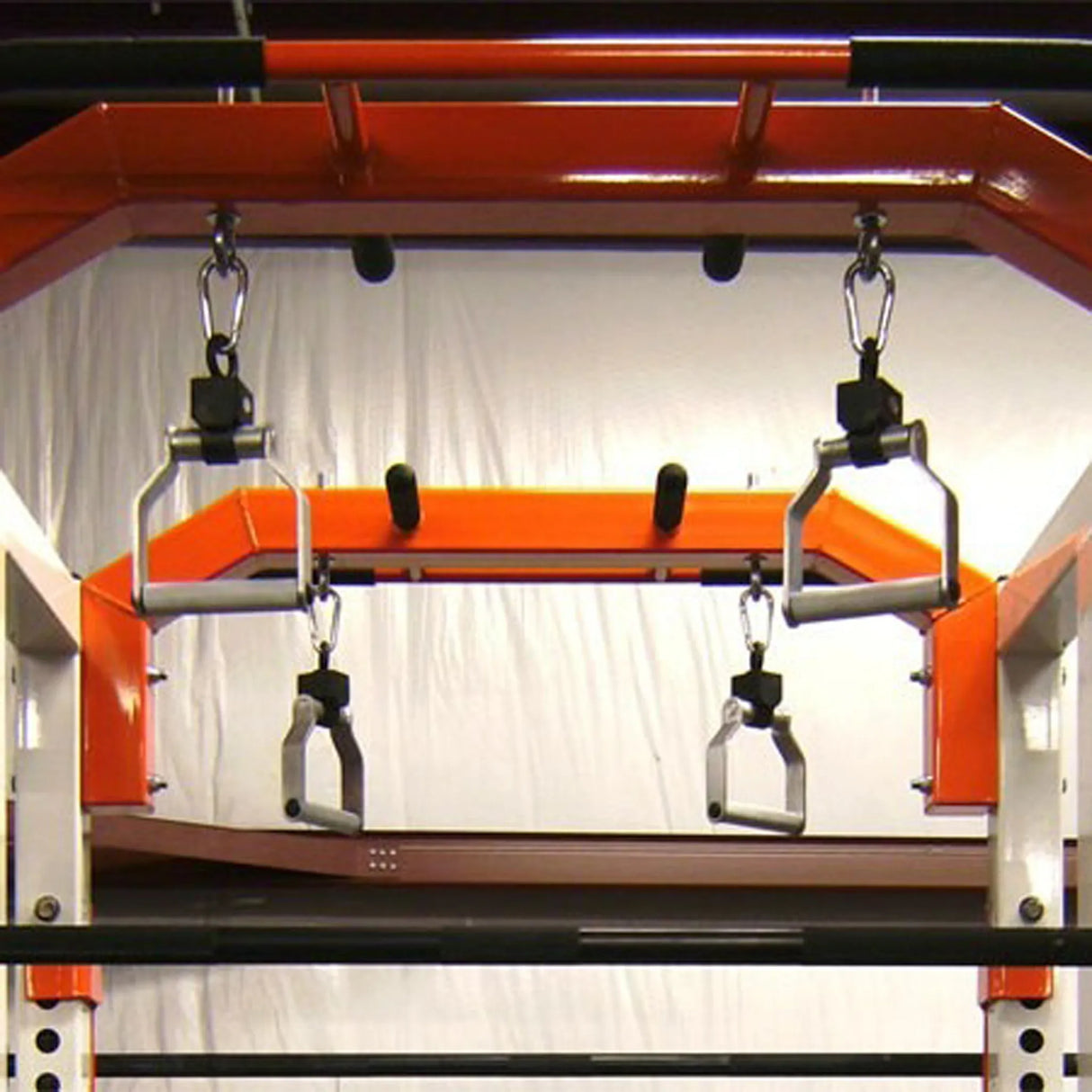 Metal pull-up handles hanging from a squat rack pull-up bar