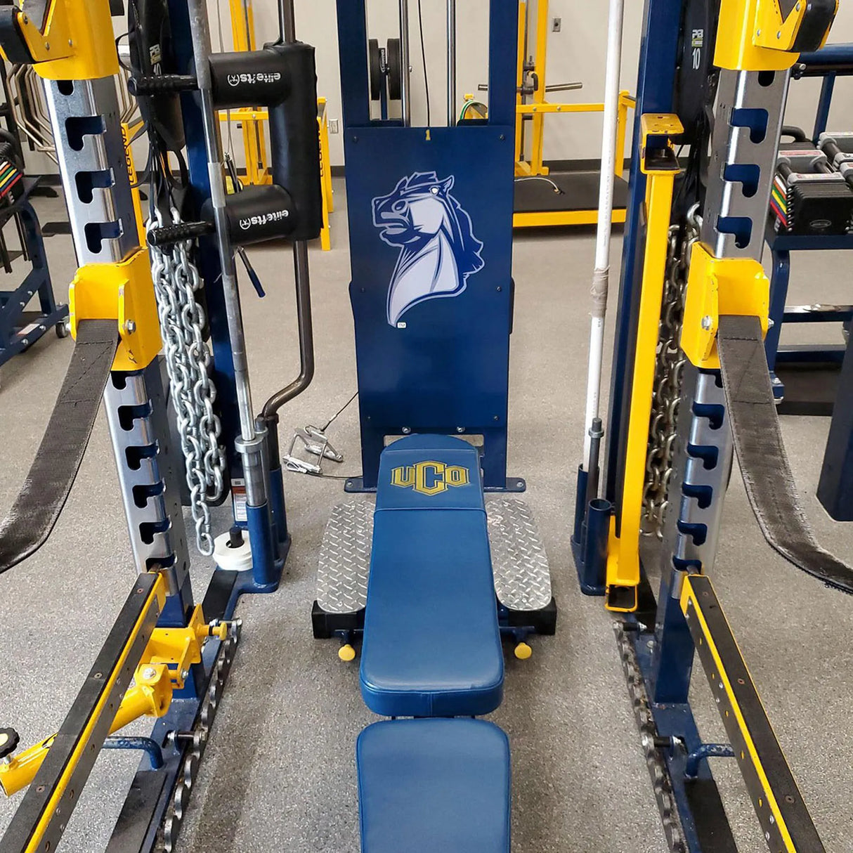 Gym equipment with UCO logo in a fitness center