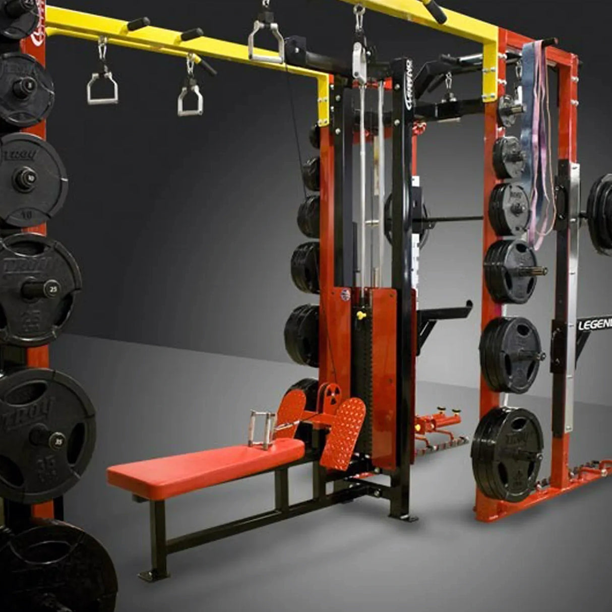 Gym equipment with weight plates and bench on a gray background