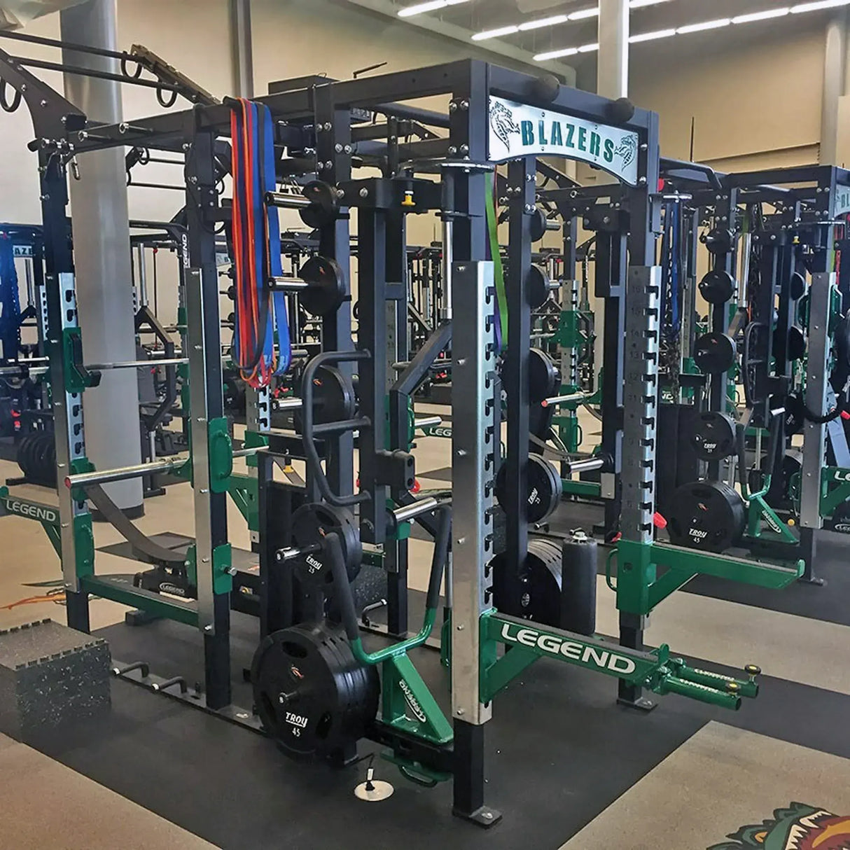 A red Legend Fitness half cage connected to the rear of a full cage