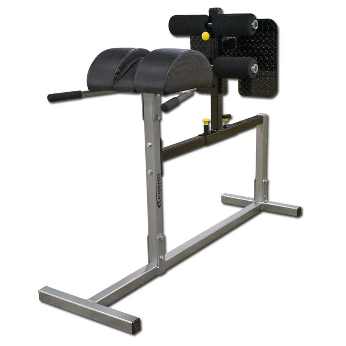 A silver Legend Fitness glute ham developer with black pads on a white background