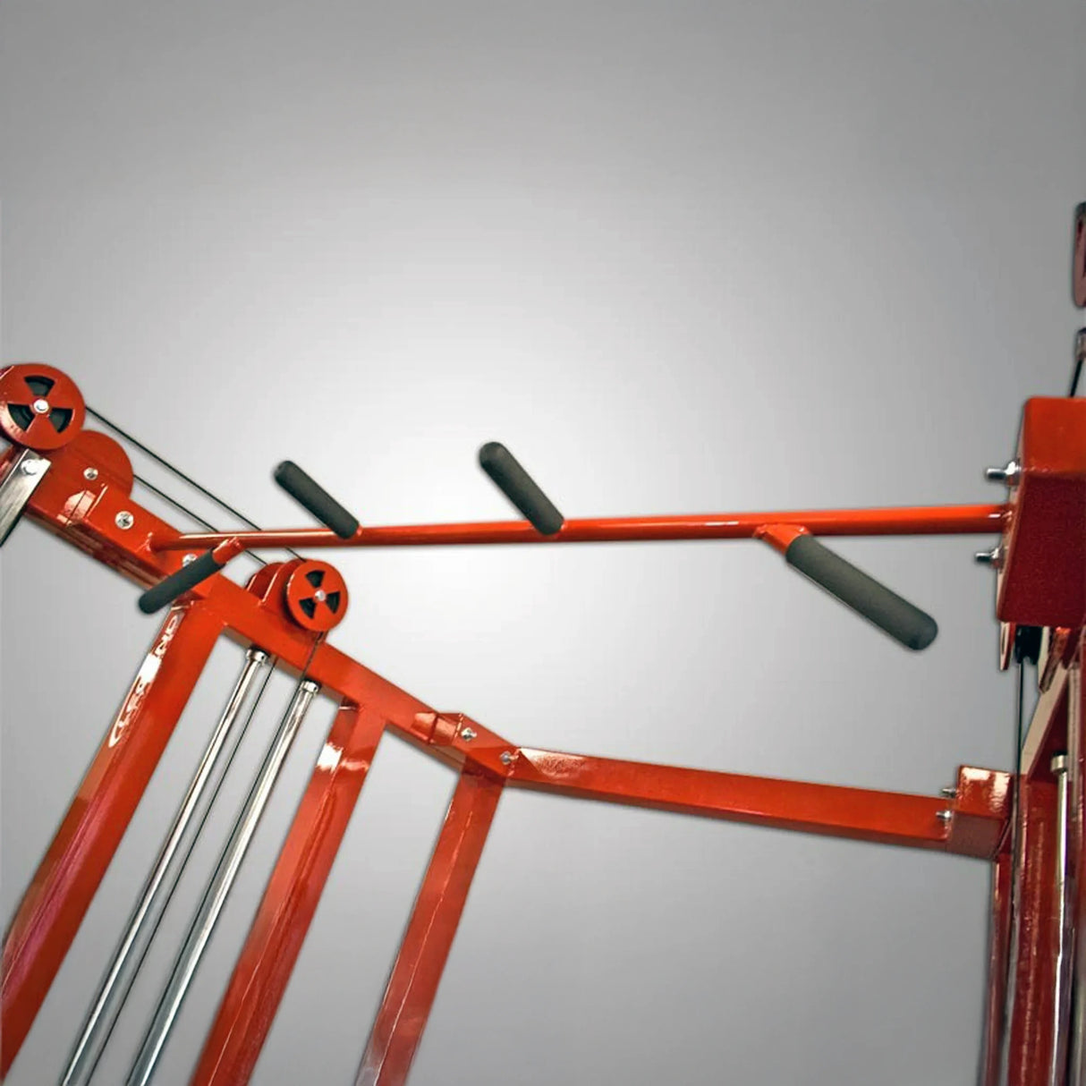 A close-up of the Legend Fitness 953 Functional Trainer Machine—by Legend Fitness—features padded black handles and metal rods against a plain gray background.