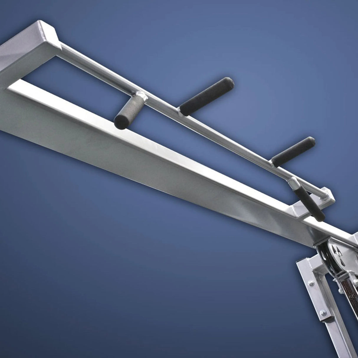 A close-up of the Legend Fitness 954 Cable Crossover with Adjustable Pulleys by Legend Fitness, showing four black foam handles and metal components against a blue background.