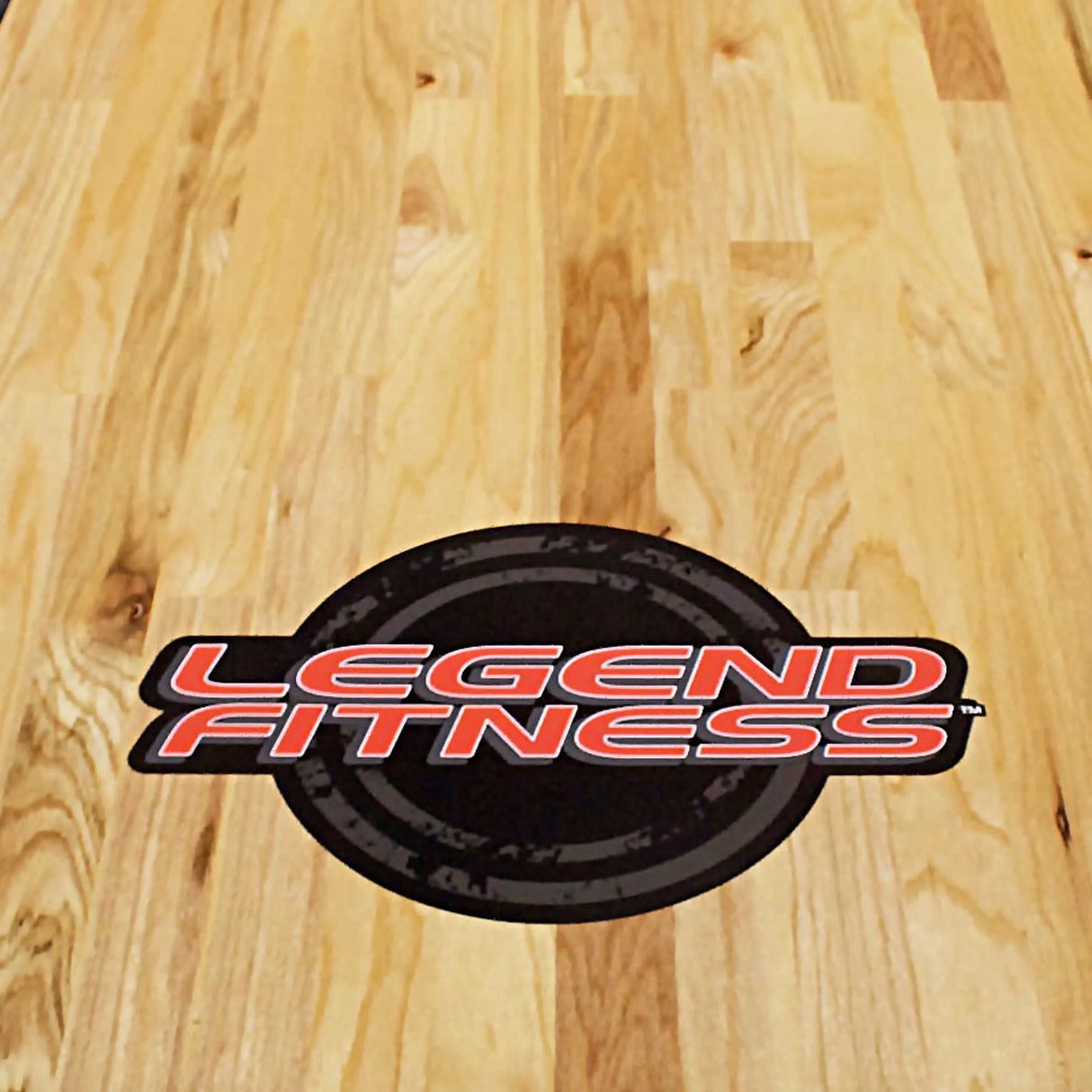 Legend Fitness logo on a wooden floor background