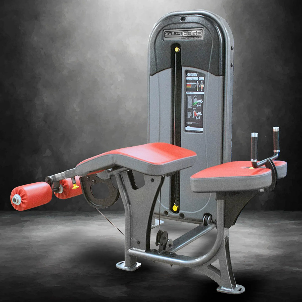 Gym machine with red padding on a dark background