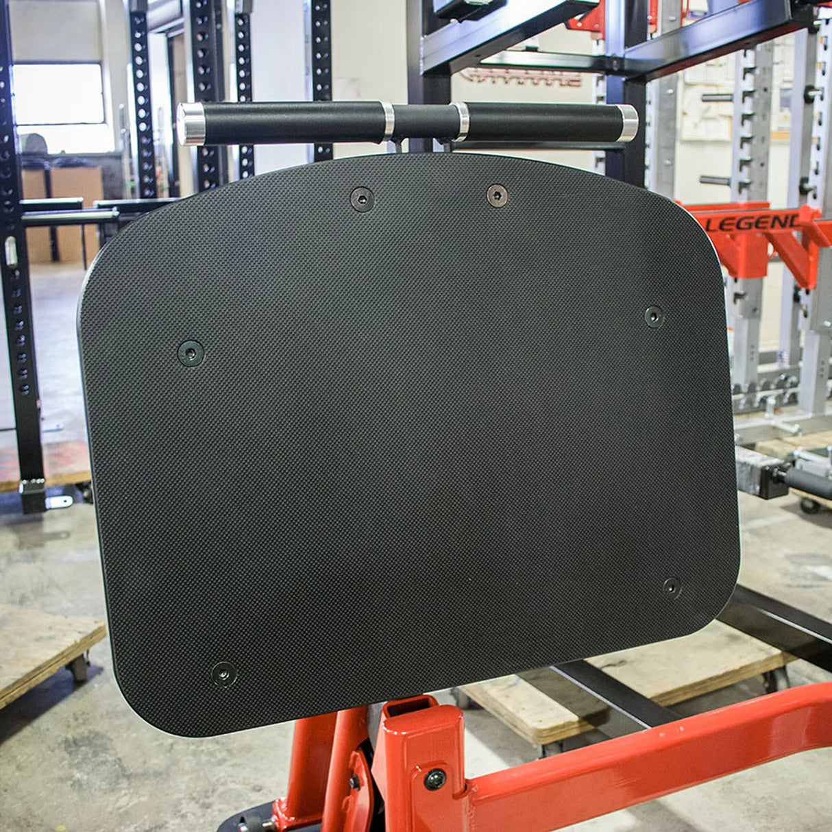 Black footplate on a mechanical arm in an industrial setting