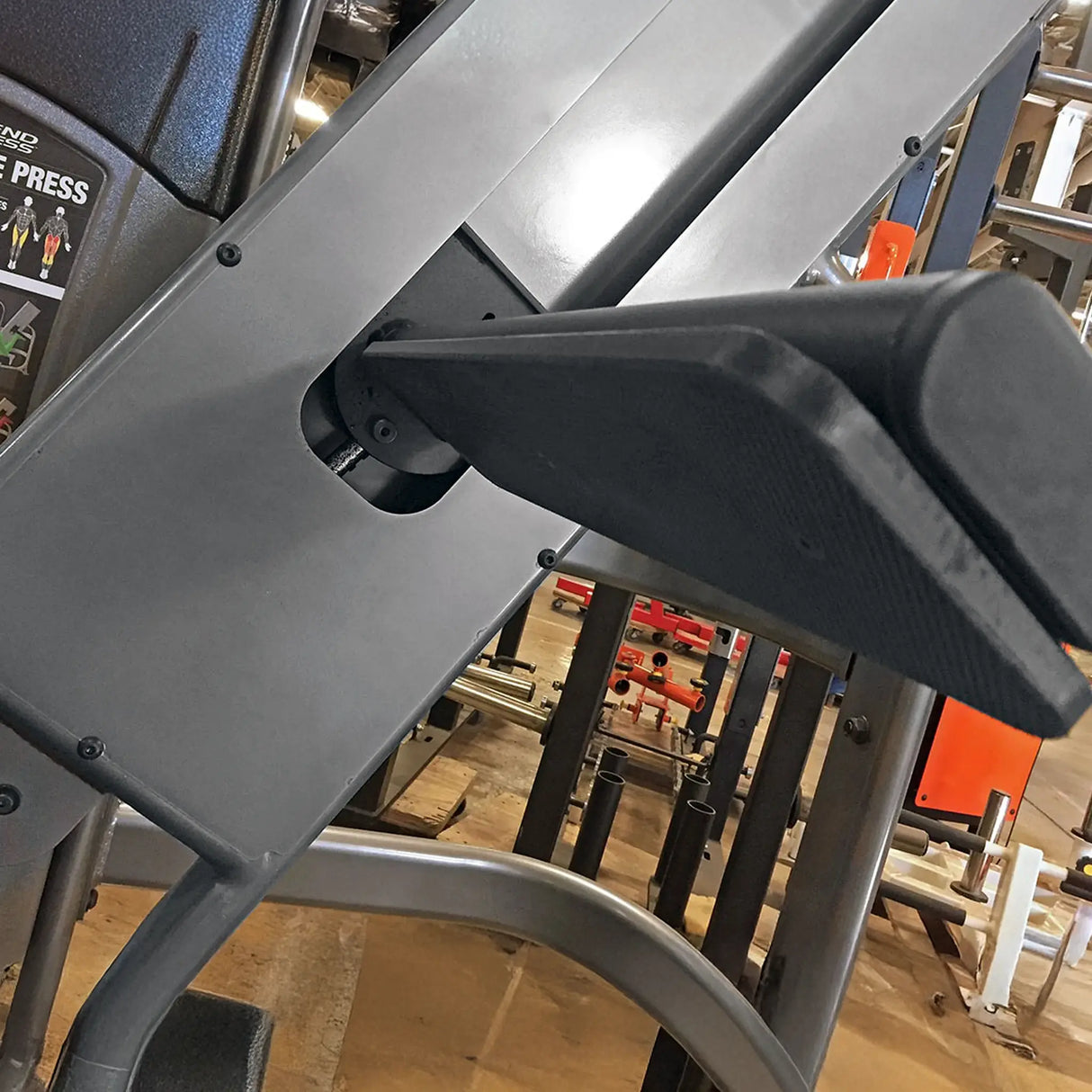 Close-up of a gym machine with blurred gym equipment in the background