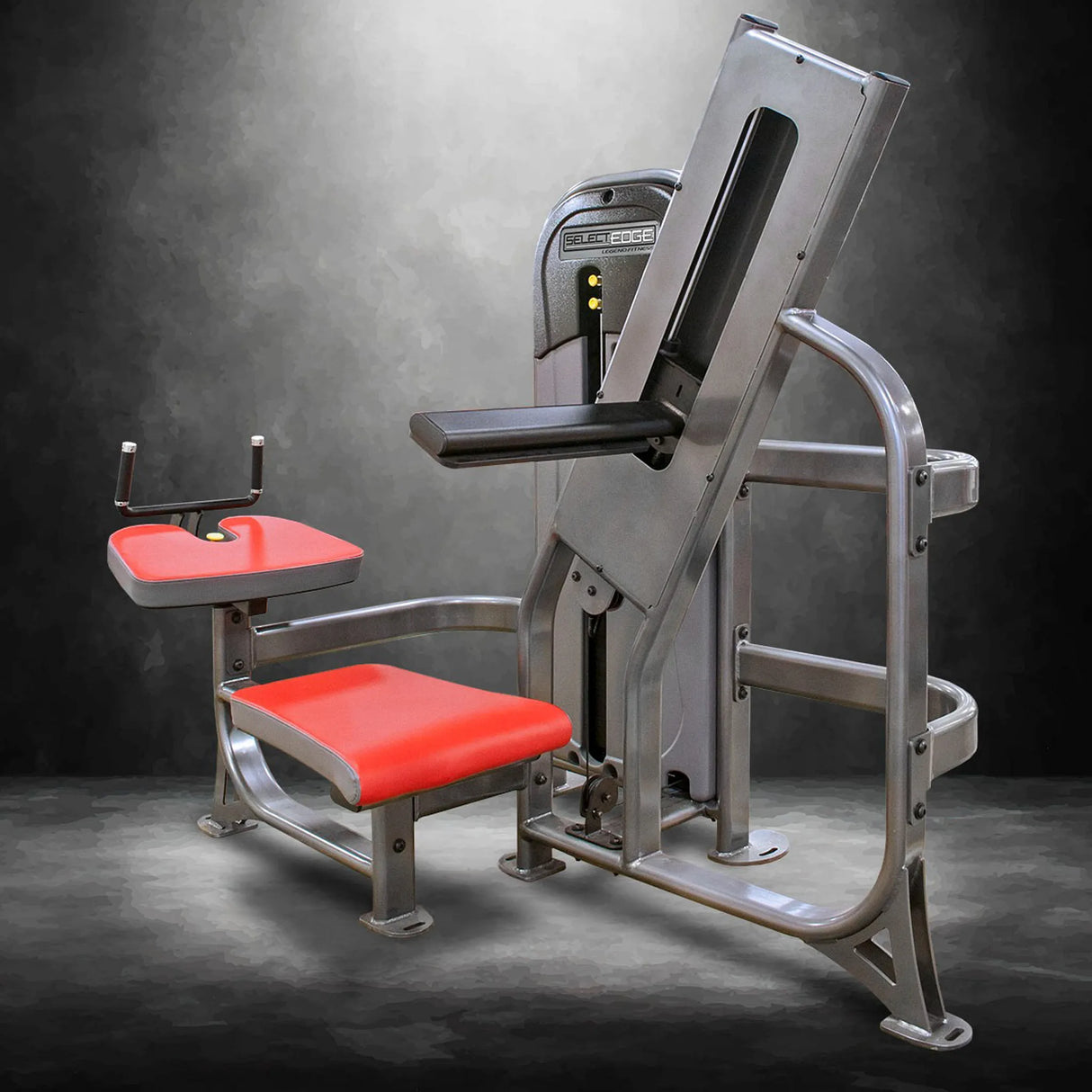 Gym machine with red padding on a dark background