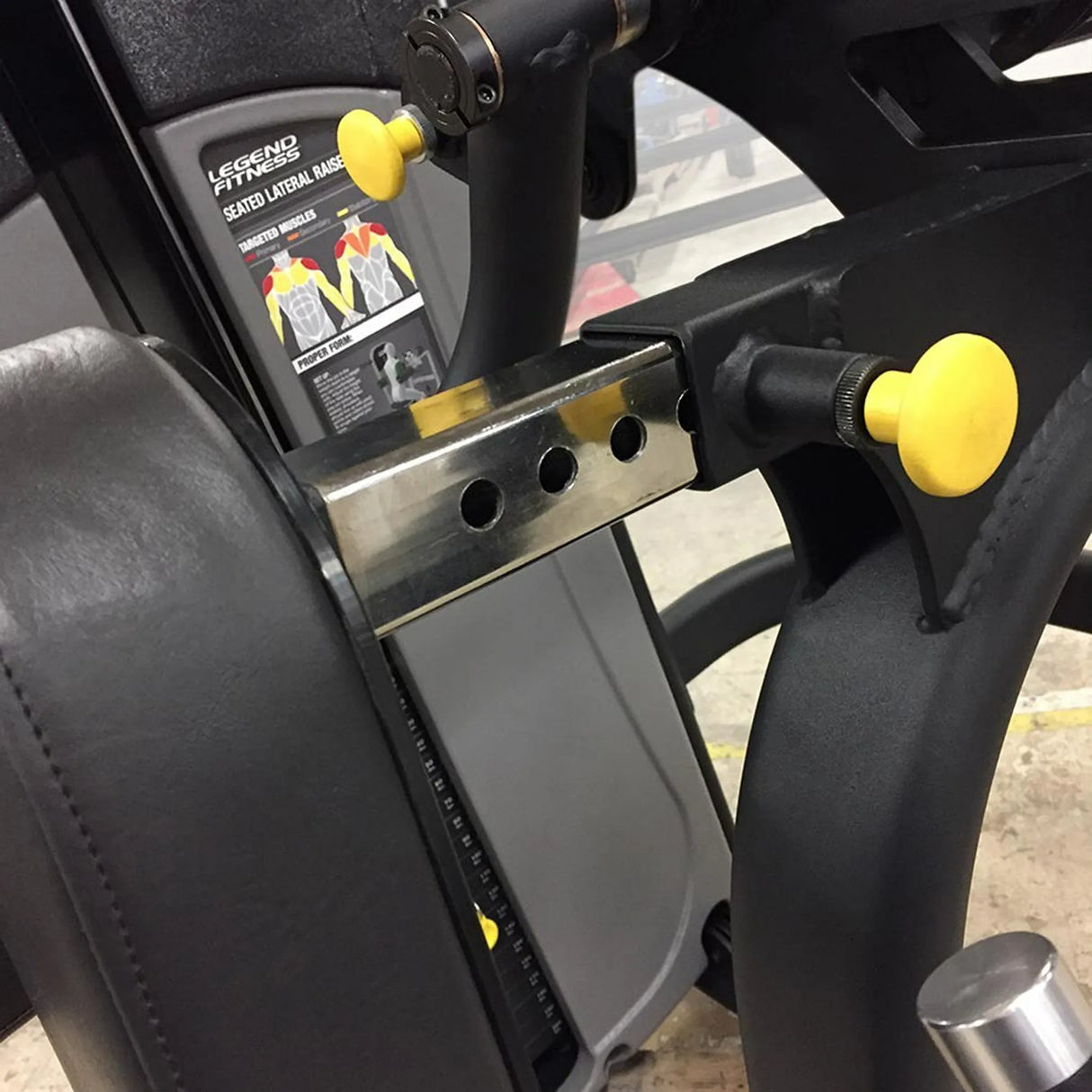 Close-up of a black piece of exercise equipment with yellow pop-pins and Legend Fitness branding.