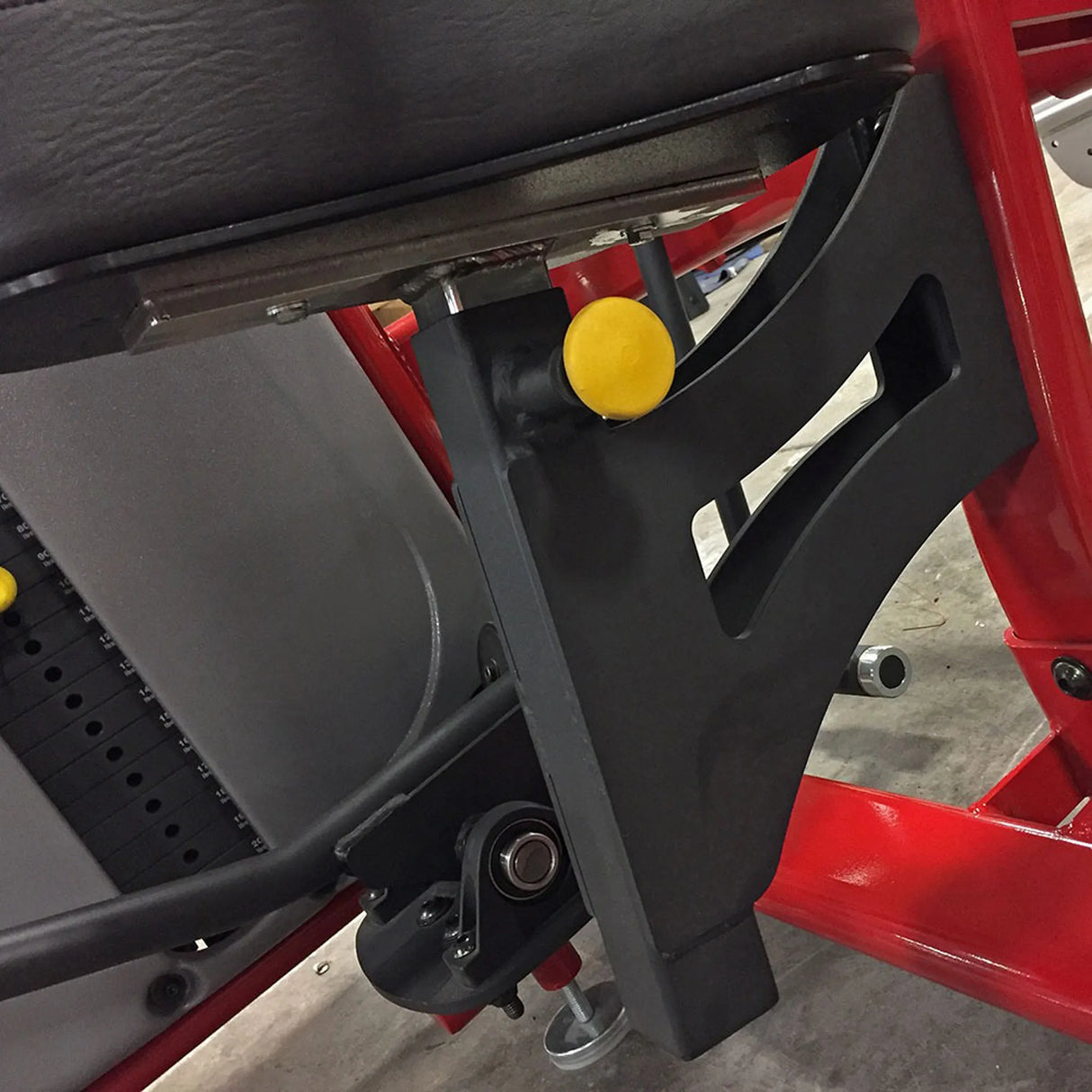Close-up of a red and black mechanical component with a yellow pop-pin
