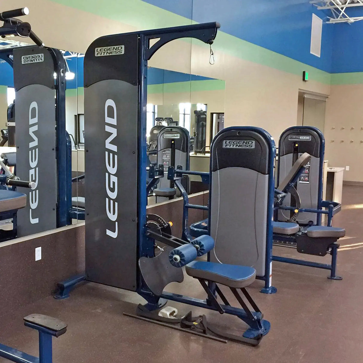 Gray and blue gym machine with 'Legend Fitness' branding in a gym setting